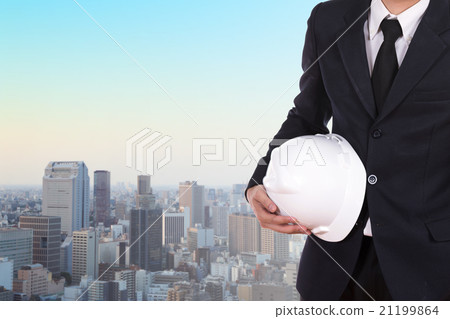 engineer holding white helmet with city background engineer holding white helmet with city background 21199864