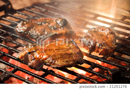 Grilling marinated meat Grilling marinated meat 21201276
