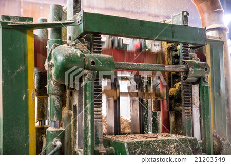 Machine sawing wood and sawdust flying Machine sawing wood and sawdust flying 21203549
