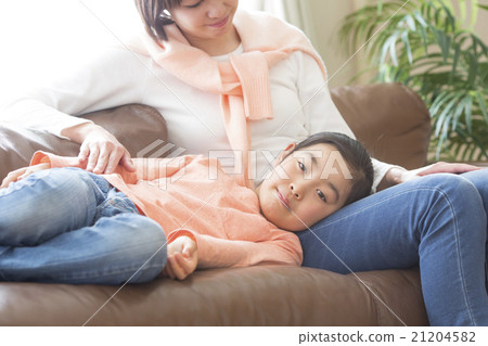 A girl sleeping on her mother's knee pillow A girl sleeping on her mother's knee pillow 21204582