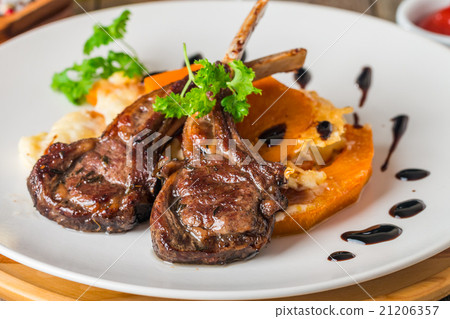 Roasted lamb ribs with  grilled pumpkin 21206357