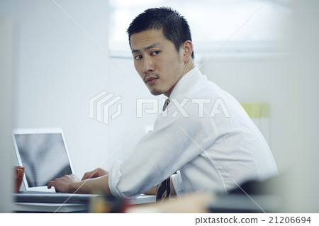 Businessman using a personal computer Businessman using a personal computer 21206694