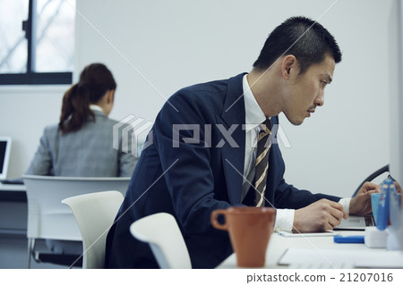 Businessman using a personal computer Businessman using a personal computer 21207016
