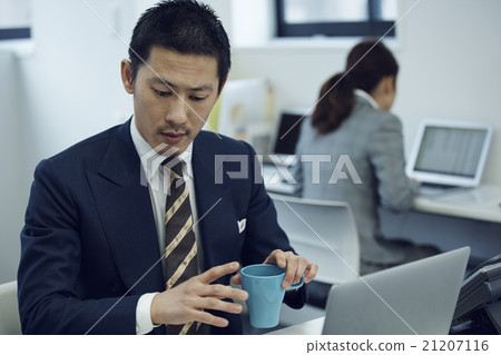 A businessman with a cup A businessman with a cup 21207116