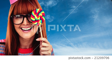 Composite image of smiling hipster woman with lollipop and hat p 21209706