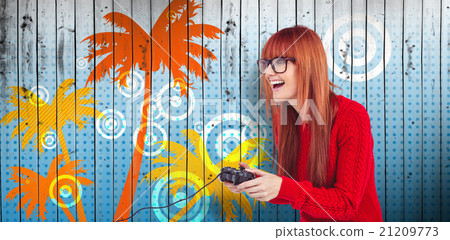 Composite image of smiling hipster woman playing video games 21209773