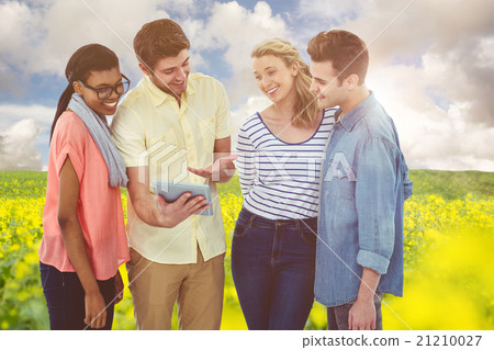Composite image of happy creative team using a tablet pc Composite image of happy creative team using a tablet pc 21210027