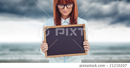 Composite image of smiling hipster woman holding blackboard Composite image of smiling hipster woman holding blackboard 21210207