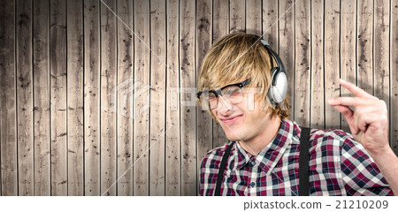Composite image of cheerful blond hipster listening to music 21210209