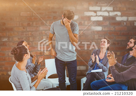 Composite image of rehab group applauding delighted man standing Composite image of rehab group applauding delighted man standing 21210320