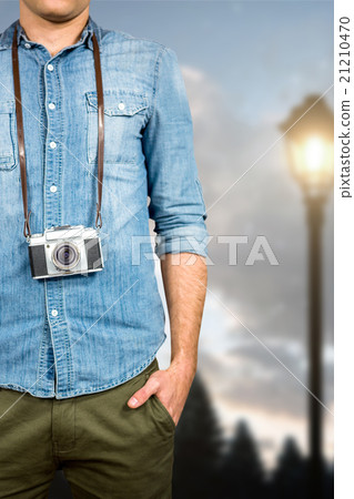 Composite image of hipster man holding digital camera 21210470