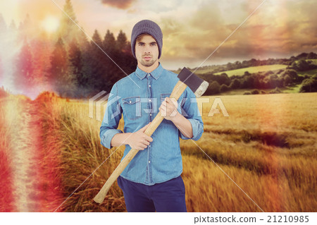 Composite image of portrait of serious hipster holding axe 21210985