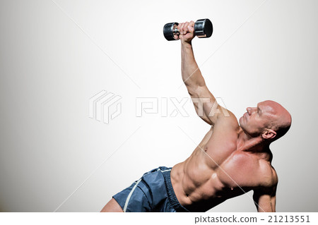 Composite image of man exercising with dumbbells Composite image of man exercising with dumbbells 21213551