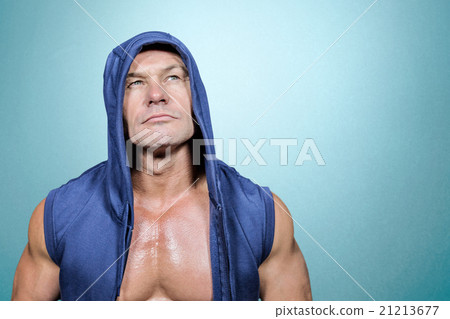 Composite image of muscular man in blue hood looking up Composite image of muscular man in blue hood looking up 21213677