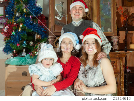 Happy family in santa hats celebrating Christmas 21214613