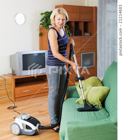 woman cleaning living room woman cleaning living room 21214683