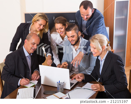 Colleagues looking at laptop. Colleagues looking at laptop. 21215197