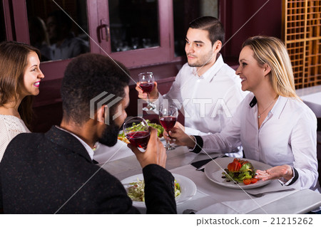 middle class people enjoying food in cafe and talking 21215262