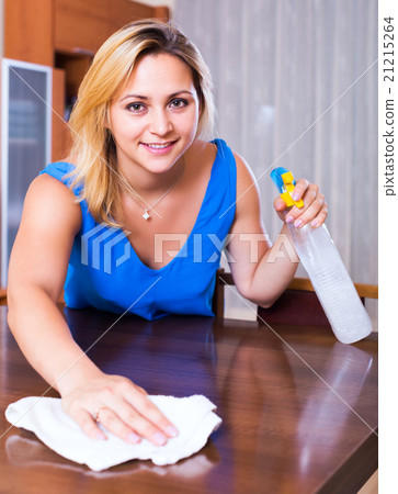 Girl dusting furniture indoors 21215264