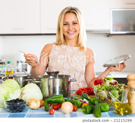 Girl cooking with veggies at home. 21215299