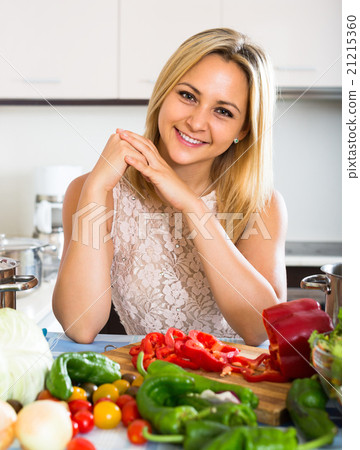 Girl cooking with veggies at home. 21215360