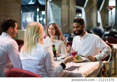 middle class people enjoying food in cafe terrace middle class people enjoying food in cafe terrace 21215370