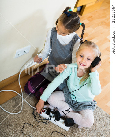 children playing with sockets and electricity indoors 21215564