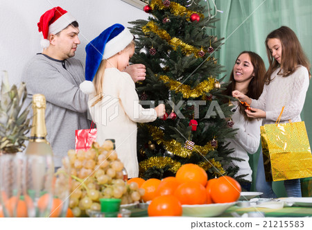 people decorating Christmas tree 21215583