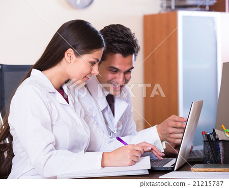 Family doctors with stethoscope working in office together Family doctors with stethoscope working in office together 21215787
