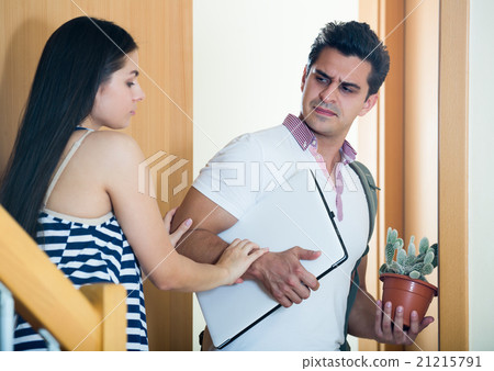 Husband leaving woman with luggage. 21215791