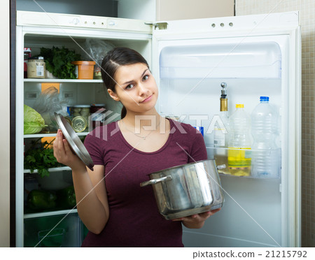 Woman sniffing at foul food 21215792