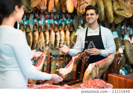 Female customer buying Spanish jamon 21215848