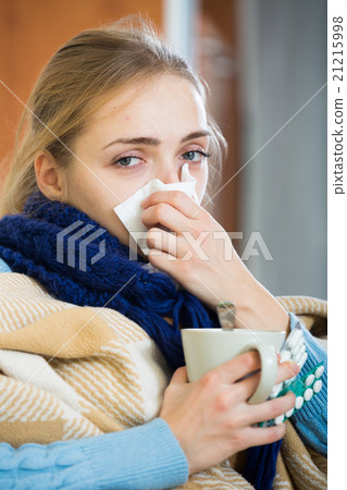 Young woman suffering of cold and having stuffy nose 21215998