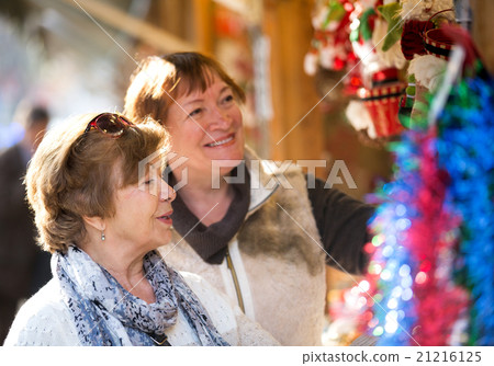 Happy mature women purchasing Christmas decorations Happy mature women purchasing Christmas decorations 21216125