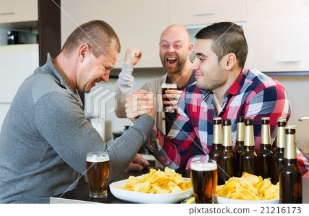Happy and drunk men armwrestling Happy and drunk men armwrestling 21216173