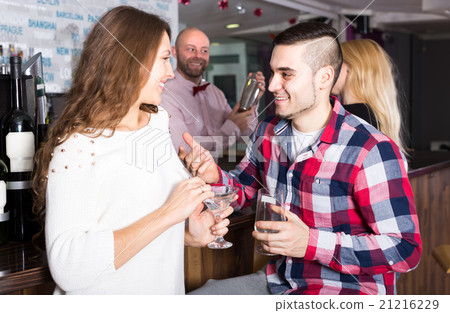 Man picking up woman in bar 21216229