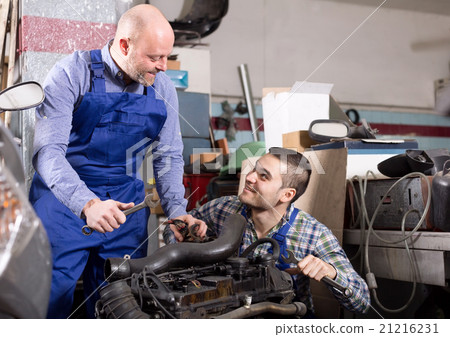 Mounting specialists in coveralls working 21216231