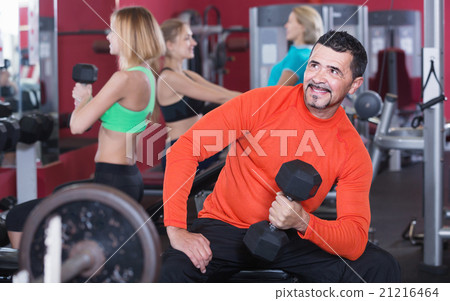 Active people weightlifting training in health club 21216464