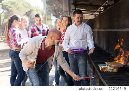 friends relaxing at grill party 21216549