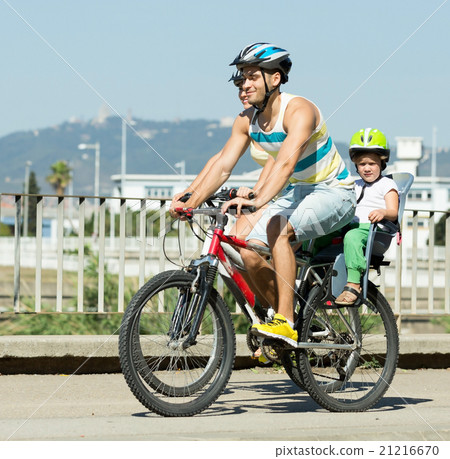 Family of four cycling on street Family of four cycling on street 21216670