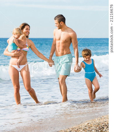 Family of four at the beach Family of four at the beach 21216676