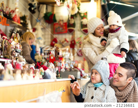Happy family choosing Christmas decoration at Christmas market 21216681