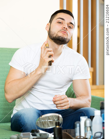 Handsome man applying perfum 21216684