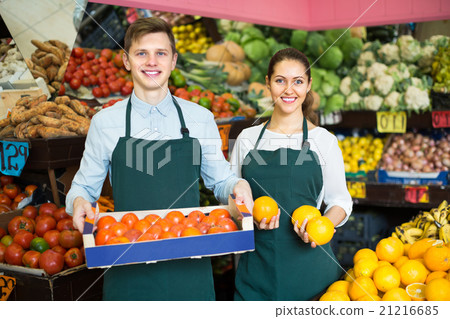 Supermarket workers selling fruits. 21216685