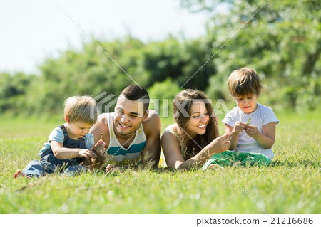 Family of four in sunny park Family of four in sunny park 21216686
