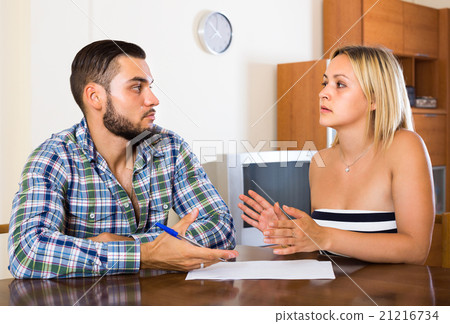 Two adults with papers. 21216734