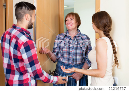 Happy couple greeting elderly mother 21216737