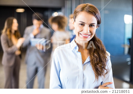 Confident businesswoman looking at camera in office 21218051