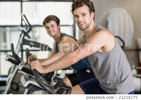 Fit people doing exercise bike 21218175