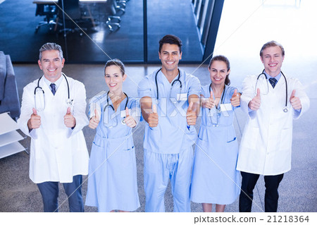 Medical team putting their thumbs up and smiling Medical team putting their thumbs up and smiling 21218364